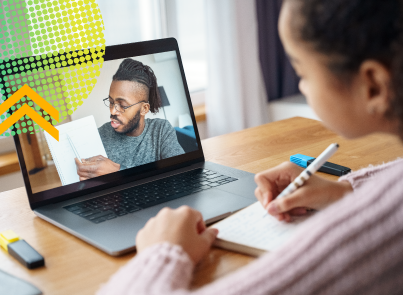 Young girl in front of laptop watching a teacher explain a concept. 