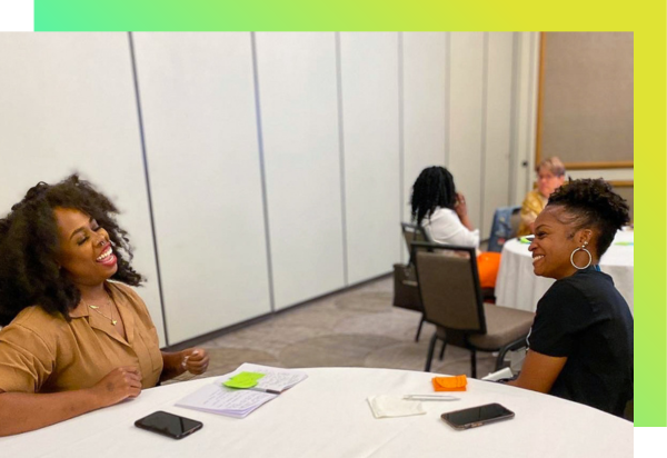 Two teachers laugh during a productive professional learning session. 