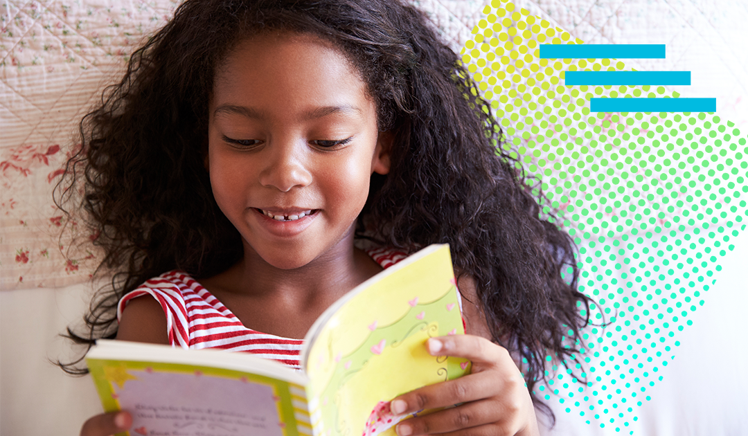 Elementary school student reading a book while lying down